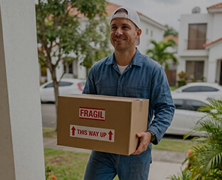 Driver delivering a parcel to a home